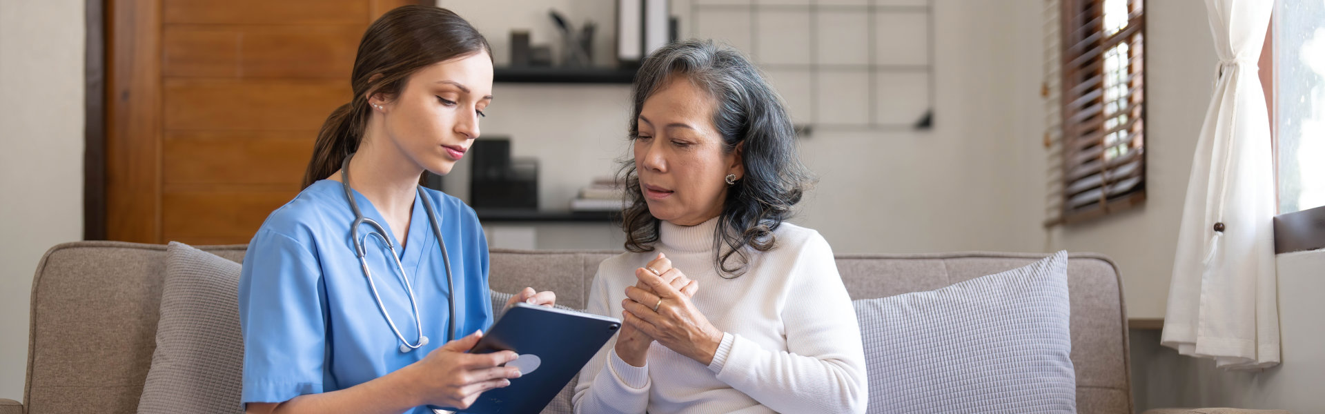 nurse and senior wathching on tablet