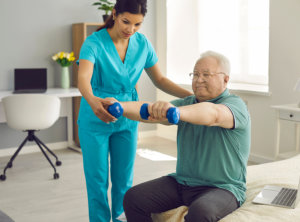 caregiver assisting senior on his exercise