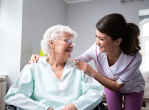 caregiver and senior looking to each other while smiing