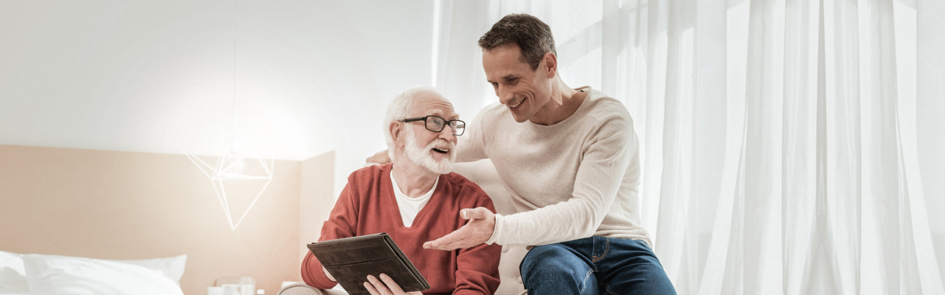 senior and caregiver reading book