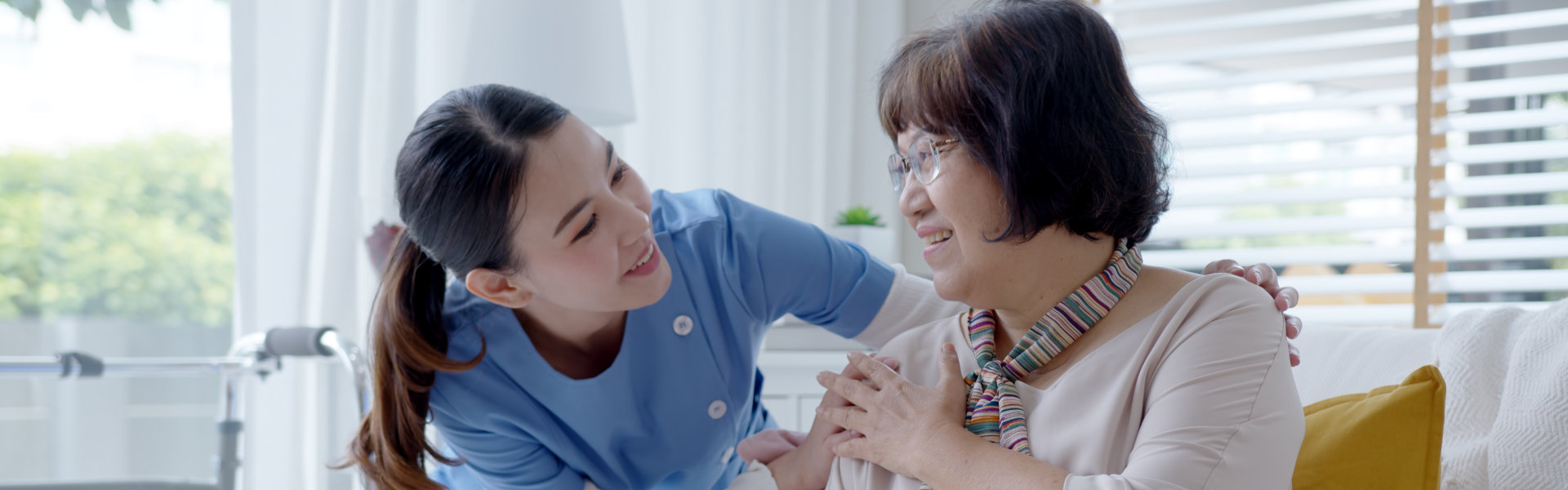 caregiver and senior looking to each other while smiling