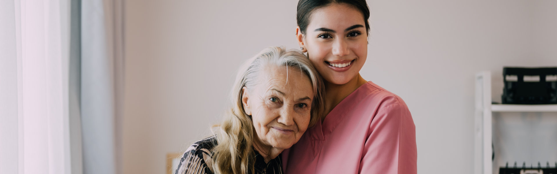 caregiver hugging senior