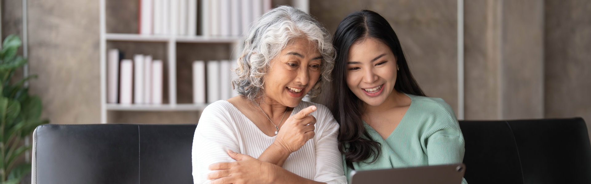 caregiver and senior doing video call on laptop